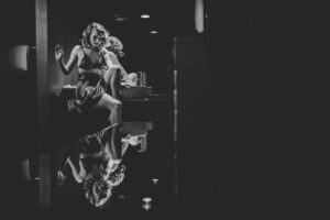 Creative location editorial fashion portrait in bathroom in black and white with reflection of model
