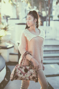 Feminine teen fashion photography with vintage pink top white collar and antique vintage purse