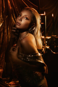 Elegant and sultry fashion studio portrait in Las Vegas with gold dress and set design