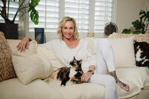 Cozy lifestyle portrait for branding in Las vegas with house cat on white couch