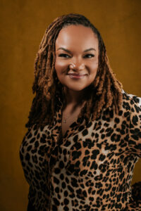 Elegant female headshot in a stylish Leopard blouse