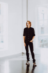 Styling fashion Senior graduation pictures in Las vegas wearing all black inside Tivoli Village